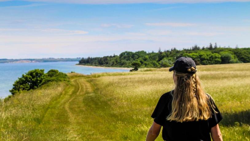 Kvinde vandrer ved Nørreklint på Tunø