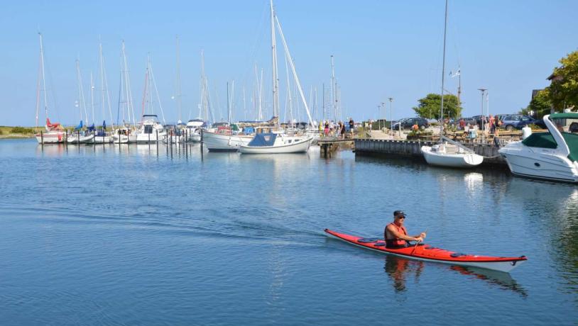 Man paddling in a kayak at Norsminde Harbour