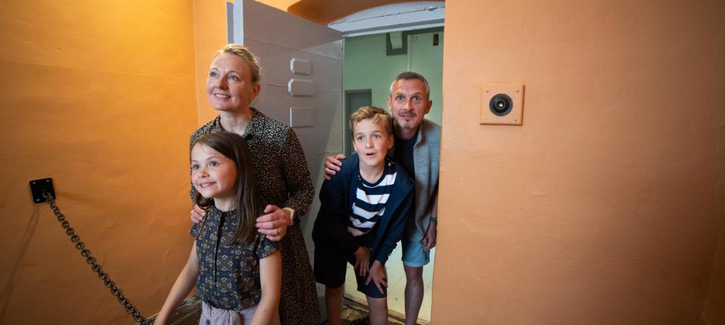 Familie ser ind i fængselscelle