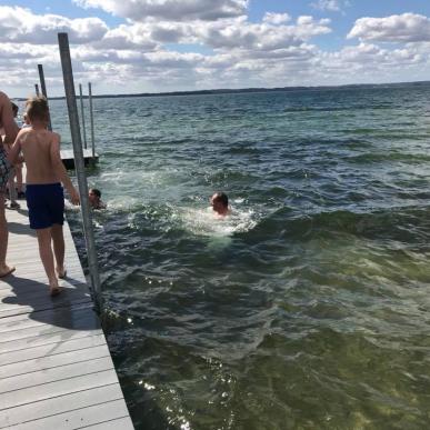 People swimming at the jetty at Rosenvold Beach